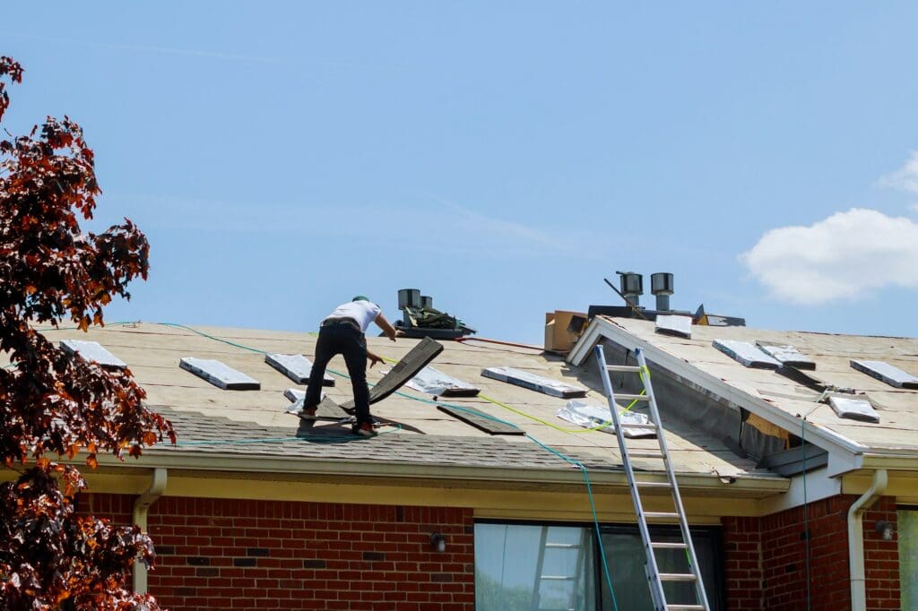 Home roof construction applying roof new shingles in apartment building