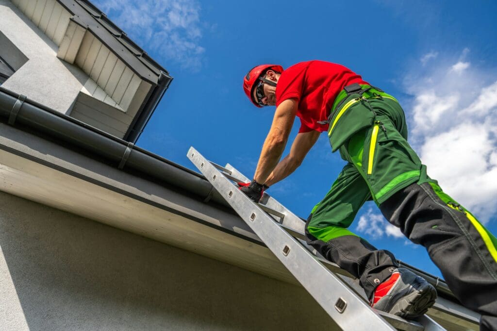 Professional Maintenance Worker Climbing a Ladder to Repair Roof Gutter on a Sunny Day new braunfels roofing company